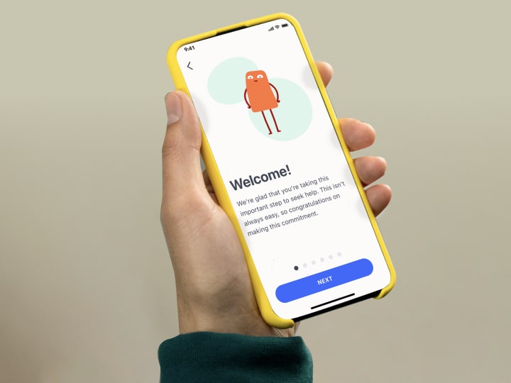 A hand holding a smartphone that's open to the Rejoyn app screen